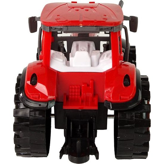 Traktor s kultivátorem červený na setrvačník